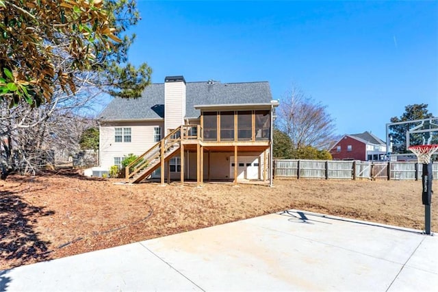 rear view of house with a sunroom and a patio