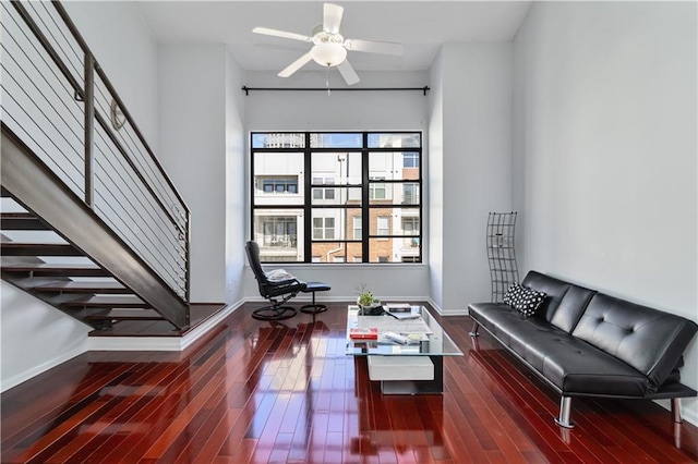 living room featuring wood-type flooring and ceiling fan