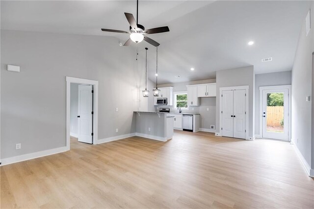 bedroom with connected bathroom, a walk in closet, dark wood-type flooring, and a raised ceiling