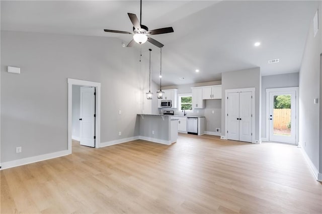 unfurnished living room featuring lofted ceiling, sink, ceiling fan, and light hardwood / wood-style flooring