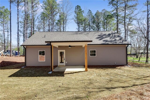 rear view of property featuring a patio area and ceiling fan