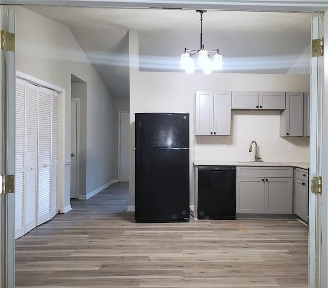 kitchen featuring black appliances, light wood finished floors, gray cabinets, and light countertops