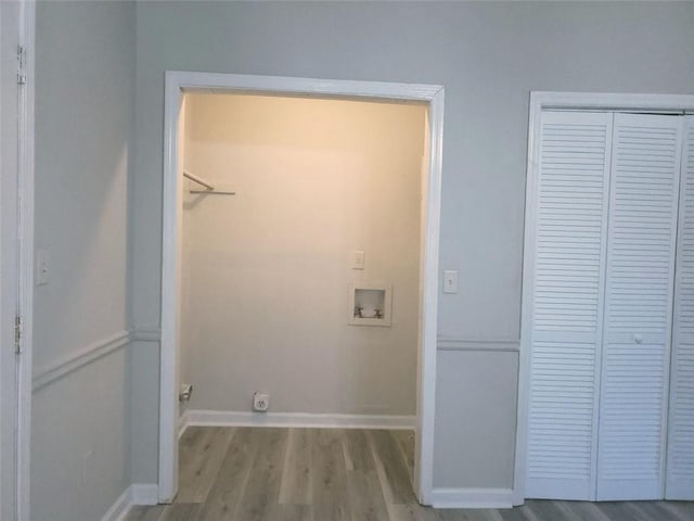 laundry room with laundry area, wood finished floors, hookup for a washing machine, and baseboards