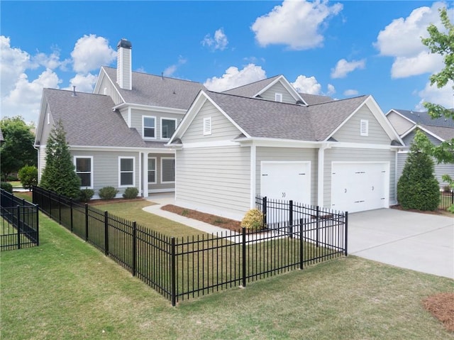 view of front of home with a garage and a front lawn