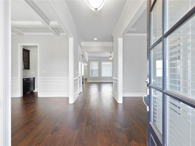 entryway featuring beam ceiling, crown molding, dark hardwood / wood-style floors, and ceiling fan