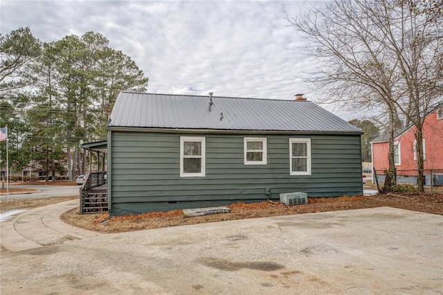 rear view of house with central AC unit