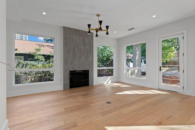 unfurnished living room with light hardwood / wood-style floors and a large fireplace