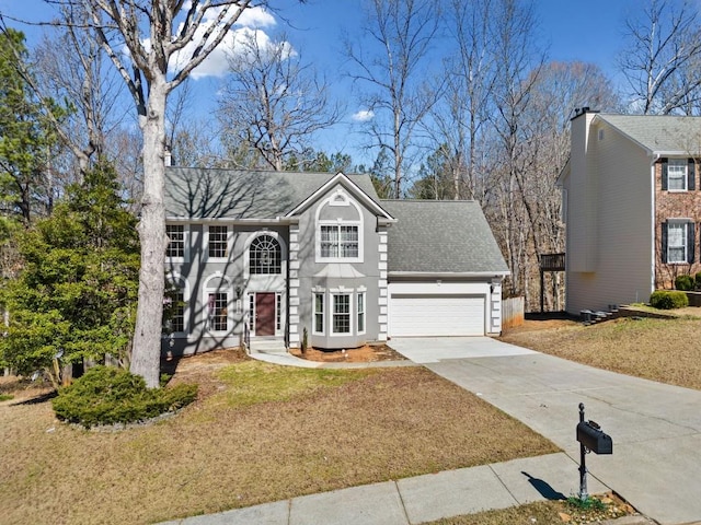 view of front of home featuring a garage, driveway, a shingled roof, and a front lawn