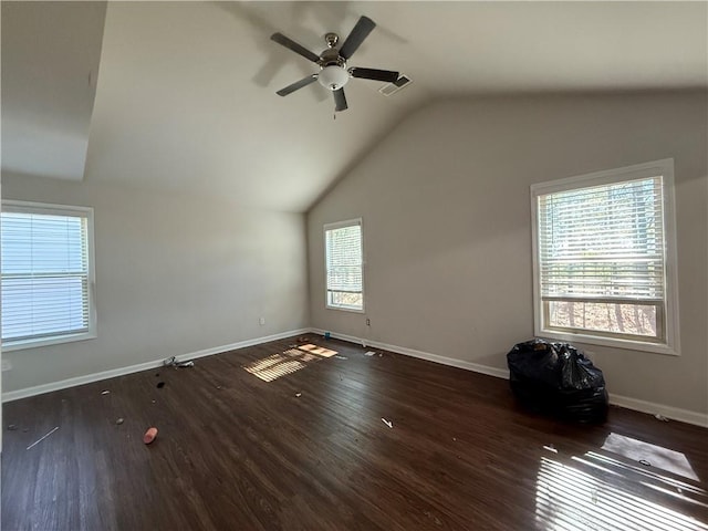 unfurnished room featuring vaulted ceiling, wood finished floors, and a wealth of natural light