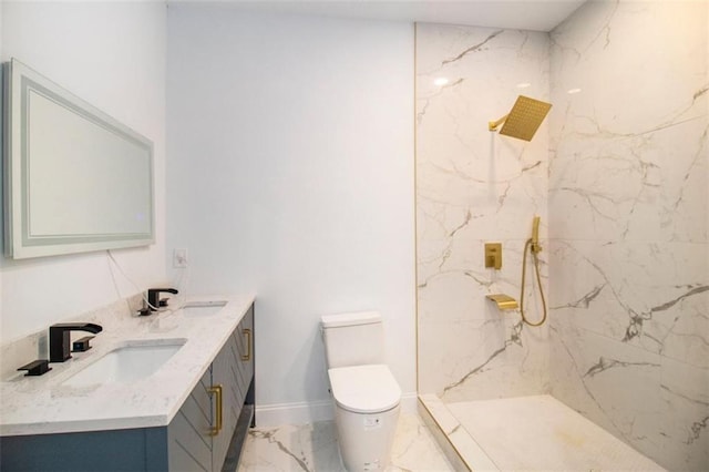 bathroom with vanity, toilet, and a tile shower