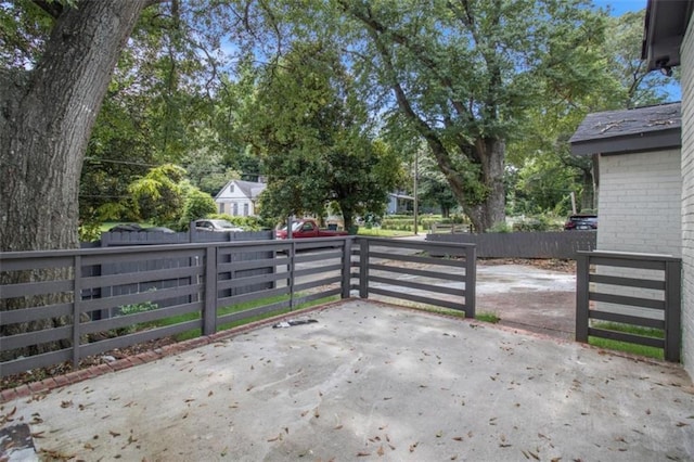 view of gate featuring a patio area