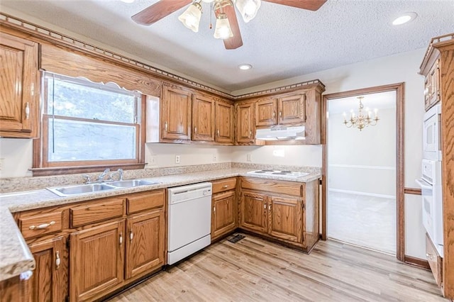 kitchen featuring sink, white appliances, light hardwood / wood-style flooring, ceiling fan, and a textured ceiling