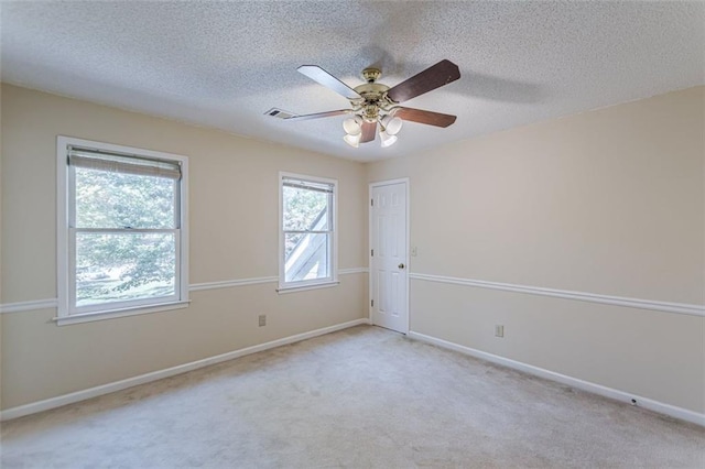 carpeted spare room with ceiling fan and a textured ceiling