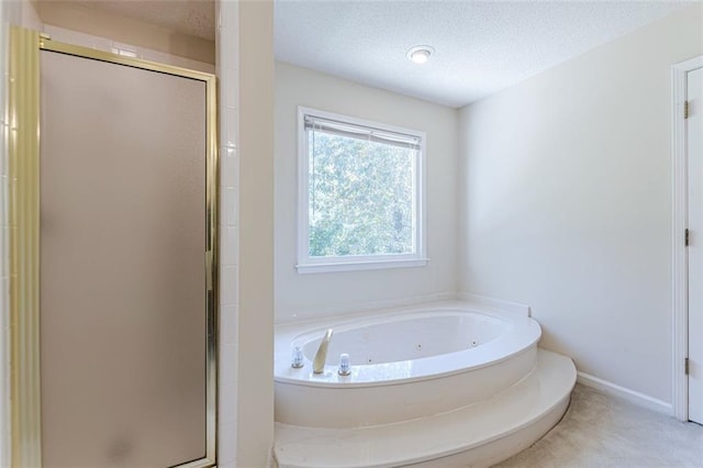 bathroom with shower with separate bathtub and a textured ceiling