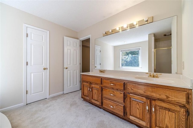 bathroom featuring vanity and a shower with door