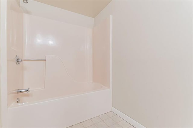 bathroom with tile patterned floors and shower / bath combination