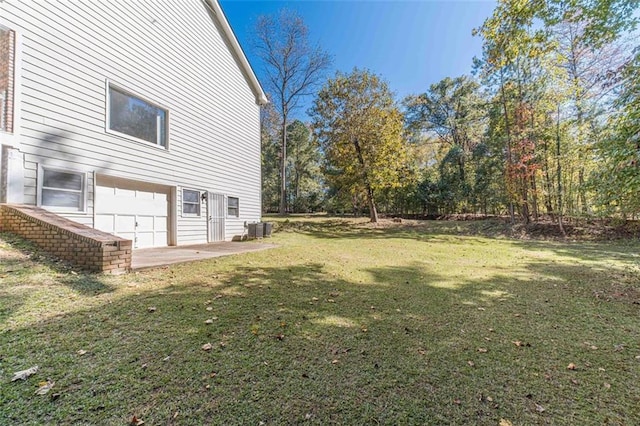 view of yard featuring a patio and central AC