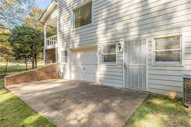 view of home's exterior with a garage, a patio, and central air condition unit