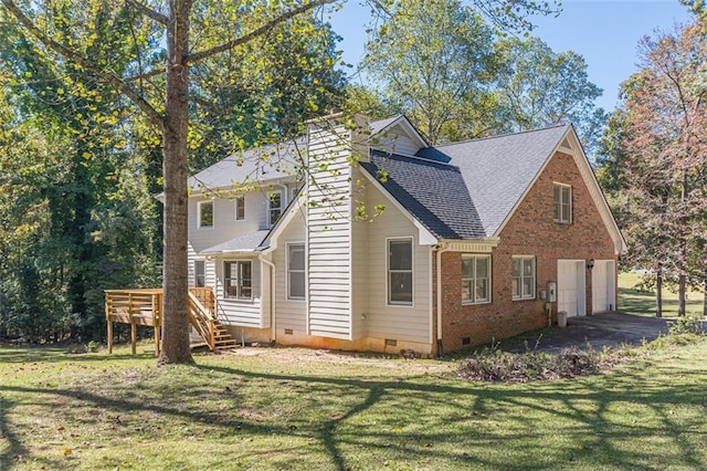 view of property exterior with a yard, a garage, and a deck