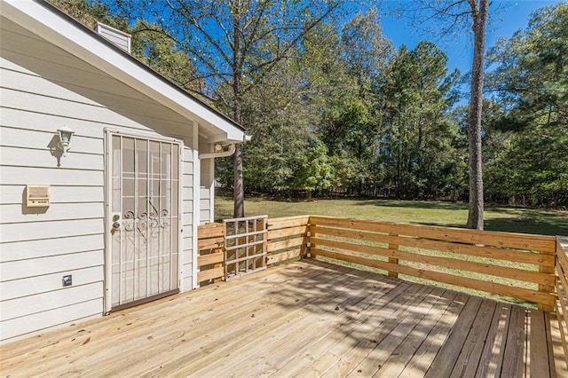 wooden deck featuring a lawn