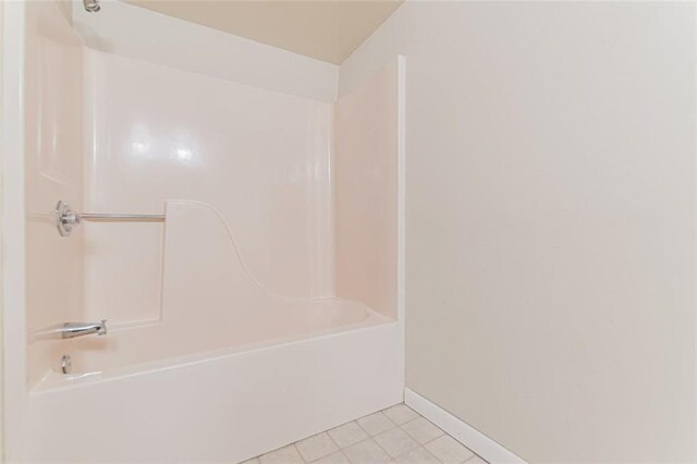 bathroom featuring tile patterned flooring and shower / bathtub combination