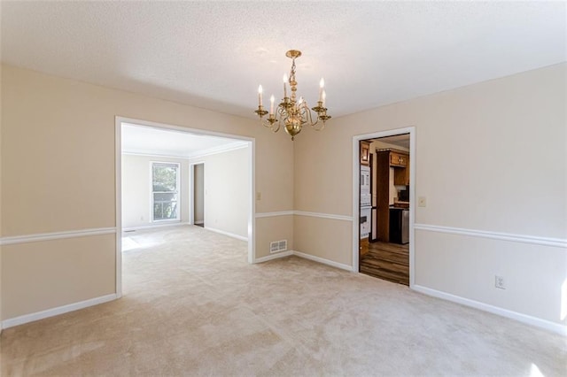 unfurnished room with crown molding, a chandelier, and light carpet