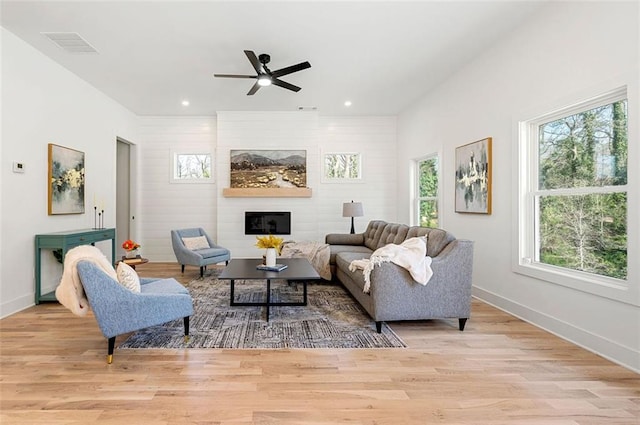 living area featuring recessed lighting, wood finished floors, baseboards, and ceiling fan