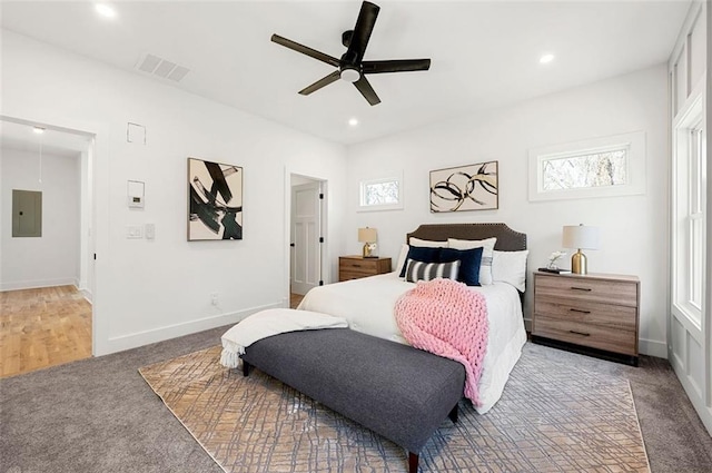 carpeted bedroom with visible vents, baseboards, electric panel, recessed lighting, and ceiling fan