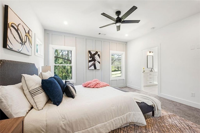 bedroom featuring visible vents, multiple windows, light colored carpet, and baseboards