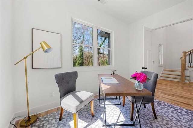 home office featuring baseboards and wood finished floors