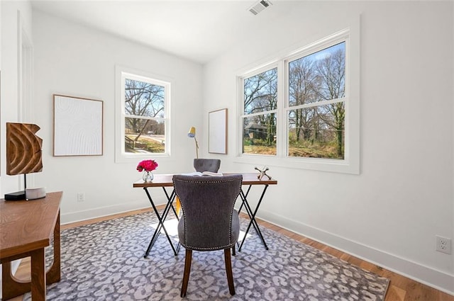 home office with visible vents, baseboards, and wood finished floors