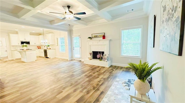 1540 Ox Bridge Ct, Lawrenceville, GA 30043 - unfurnished living room featuring light wood-style flooring, beamed ceiling, coffered ceiling, crown molding, and baseboards