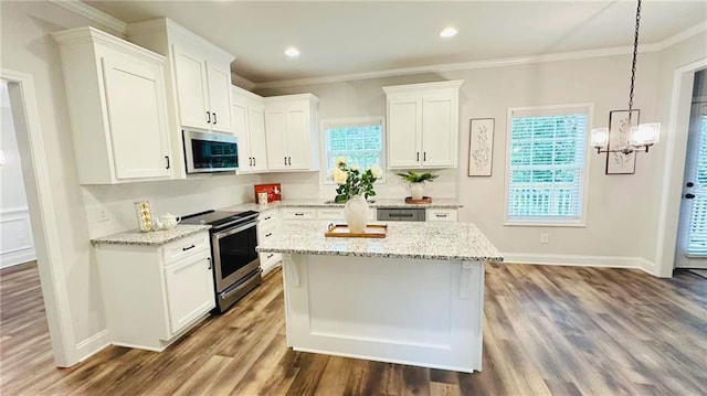 1540 Ox Bridge Ct, Lawrenceville, GA 30043 - kitchen with appliances with stainless steel finishes, white cabinetry, wood finished floors, light stone countertops, and crown molding