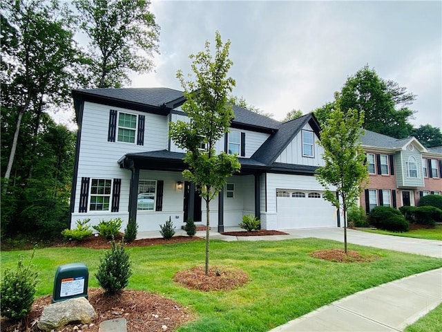 1540 Ox Bridge Ct, Lawrenceville, GA 30043 - view of front of house featuring driveway, a front yard, a garage, and board and batten siding