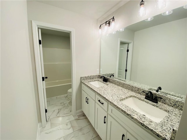 1540 Ox Bridge Ct, Lawrenceville, GA 30043 - full bathroom with marble look tiles, double vanity, toilet, and baseboards