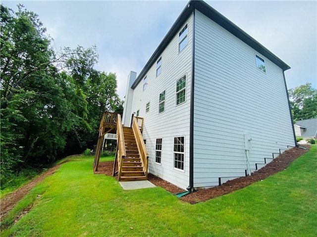 1540 Ox Bridge Ct, Lawrenceville, GA 30043 - view of side of home with stairway, a lawn, a wooden deck, and a chimney
