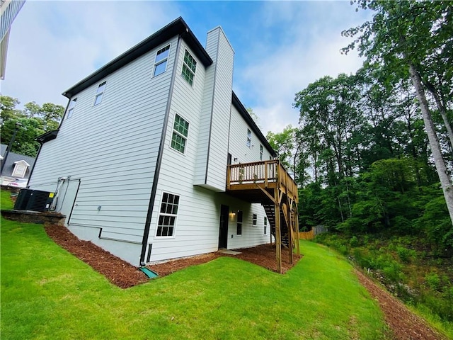 1540 Ox Bridge Ct, Lawrenceville, GA 30043 - back of house featuring central AC, stairs, a yard, a deck, and a chimney