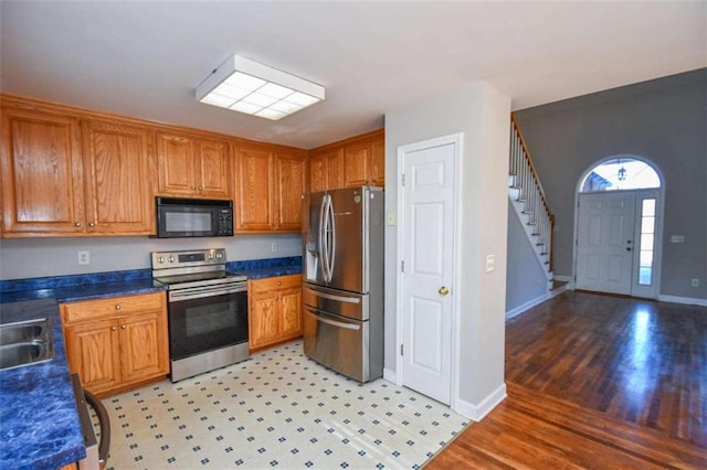 kitchen featuring light wood-type flooring, stainless steel appliances, and sink