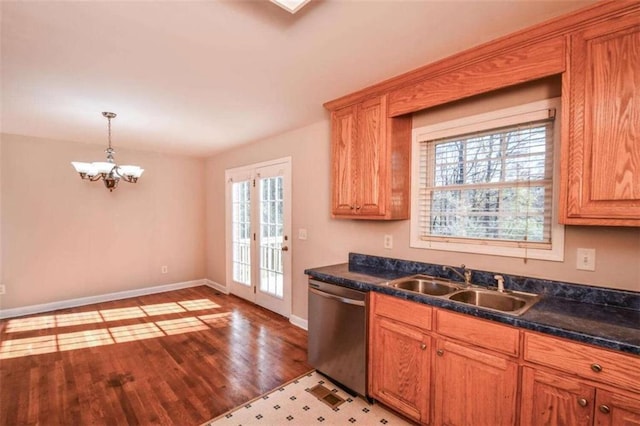 kitchen featuring a wealth of natural light, sink, dishwasher, and light wood-type flooring