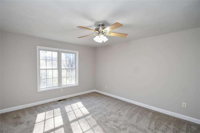 carpeted empty room featuring ceiling fan