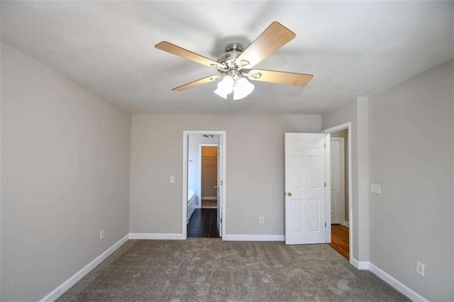 unfurnished bedroom with ceiling fan and dark colored carpet