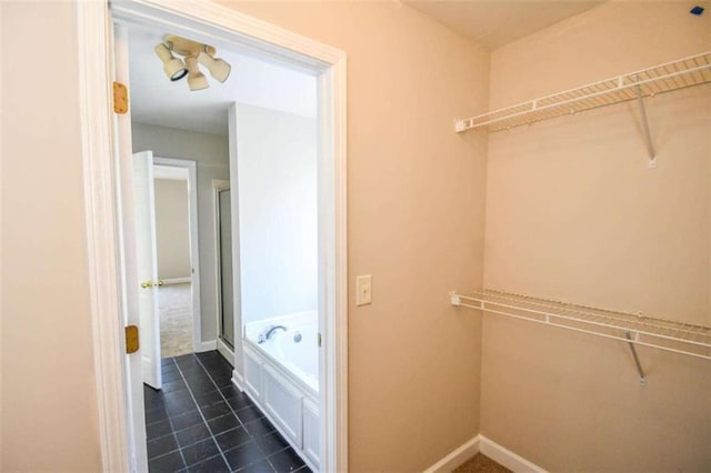 bathroom with tile patterned floors and independent shower and bath