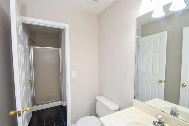 bathroom with toilet, vanity, tile patterned floors, and walk in shower