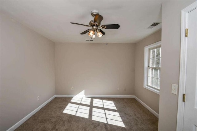 carpeted empty room featuring ceiling fan