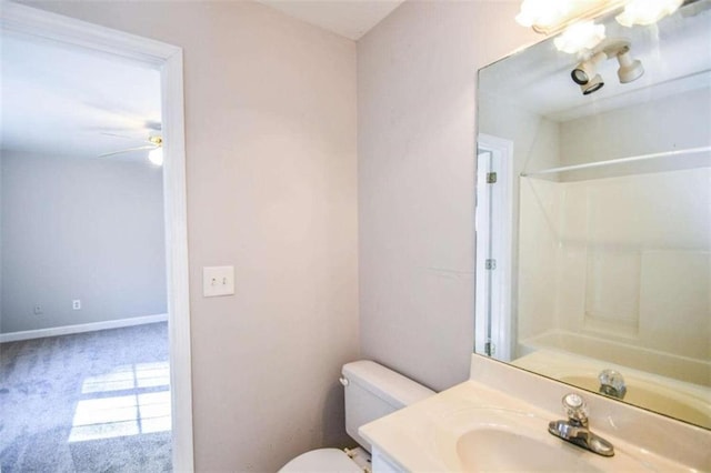 bathroom featuring walk in shower, vanity, toilet, and ceiling fan