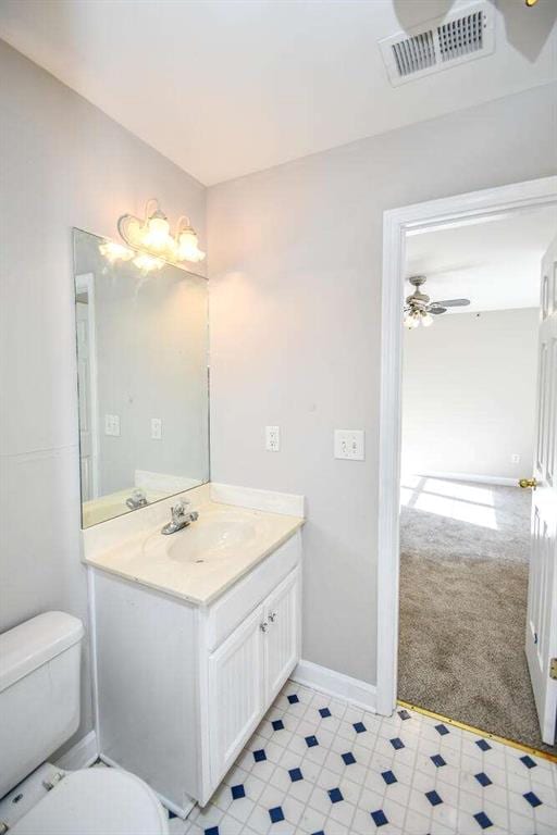 bathroom featuring ceiling fan, vanity, and toilet