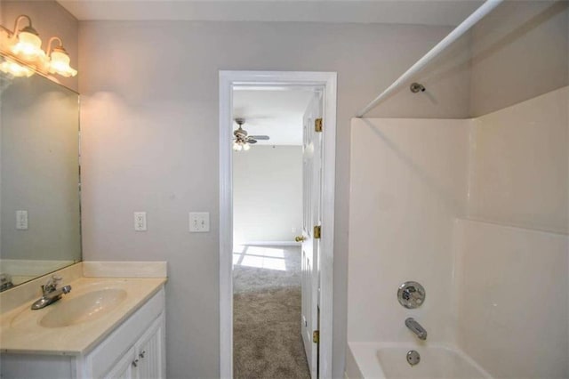 bathroom featuring vanity, ceiling fan, and tub / shower combination