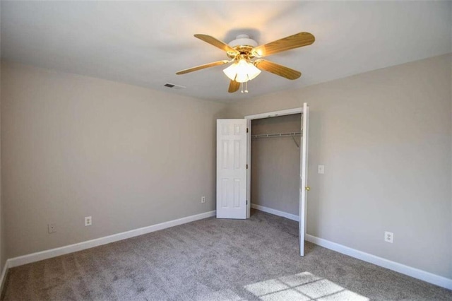 unfurnished bedroom featuring ceiling fan, a closet, and light colored carpet