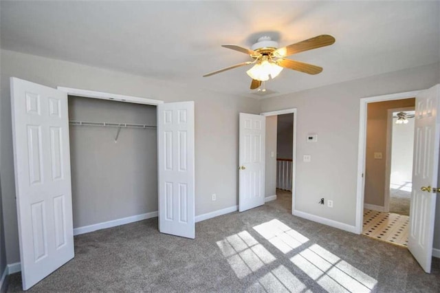 unfurnished bedroom featuring carpet flooring, ceiling fan, and a closet