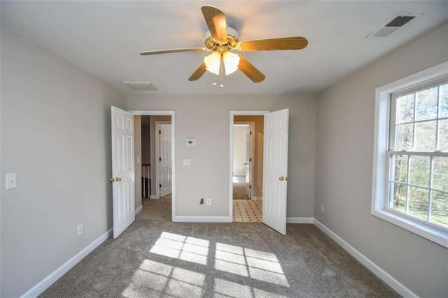 unfurnished bedroom featuring carpet flooring and ceiling fan